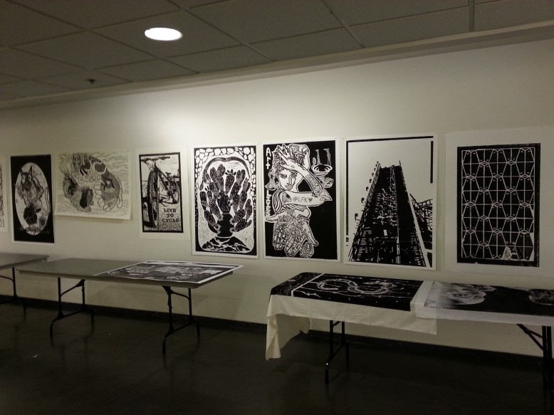 prints displayed on wall at lawrence arts center